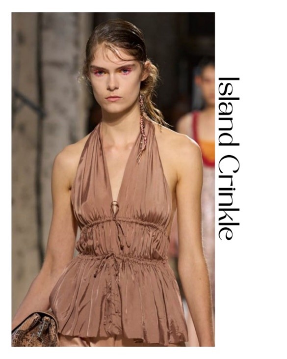 Lady wearing rusched and textured satin top